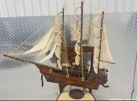 Full view of wooden sailing ship model on stand