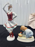 Two porcelain figurines: Hollohaza dancer and Zsolnay child with top