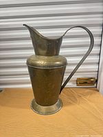 Full view of brass pitcher showing overall form