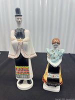 Male and female porcelain figurines side by side