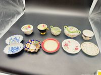 Group shot of all ten china items displayed on black background