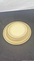 Stacked serving and dessert plates showing pattern and quantity