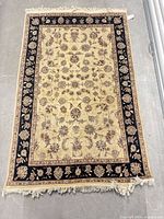 Full view of Persian Tabriz rug showing overall design and fringe
