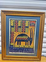 Full view of framed textile artwork