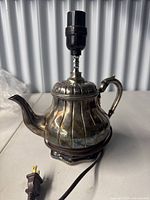 Full view of teapot lamp with cord and plug
