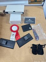 Group shot showing ribbon, wallet, crystals, card, boxes, stands and pouches