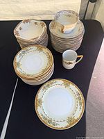 Stacks of plates, bowls and cups displayed on table