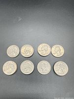 Eight Washington quarters heads side