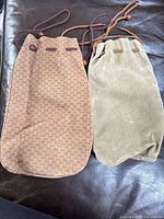 Front view of both velour drawstring bags side by side