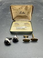 Full lot: three cufflink pairs, one tie clip, Leibo box