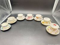All seven teacup and saucer sets in semicircle