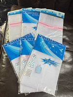 Front view of six packaged washer bags