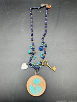 Full necklace showing beads, charms and locket