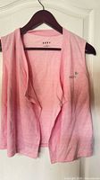 Front view of pink sleeveless DKNY open cardigan on hanger