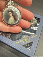 Front view showing porcelain portrait insert and bezel detail