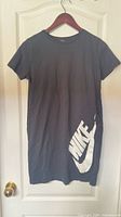 Front view of dark grey Nike t-shirt dress with white logo