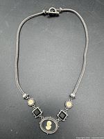 Full view of necklace laid flat showing design and length