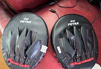 Pair of Petra focus pads showing backs with finger slots and stitching