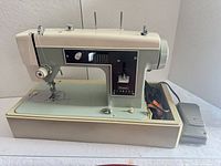 Full view of sewing machine, base and pedal