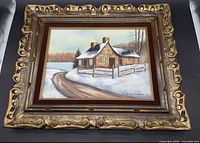 Front view of signed winter farmhouse oil painting in ornate frame