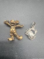 Front view of Mickey Mouse figurine and crab pendant