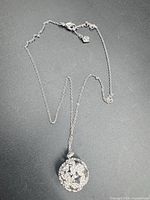 Full view of the necklace showing chain length and crystal pendant