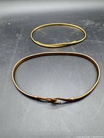 Both gold-tone belts laid flat