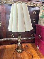 Full view of brass table lamp with shade