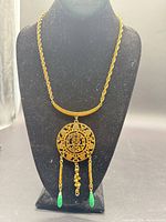 Full view of necklace on display showing pendant and chain