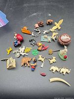 Full lot of assorted miniature toys and prizes on black background