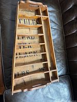 Full view of rectangular wooden tray showing tiered compartments and handle cut-outs