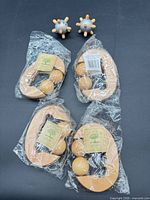 Four sealed oval wooden massagers and two peg ball massagers displayed