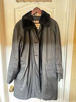 Full front view of grey Burberrys coat on hanger