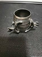 Oblique view showing full napkin ring, twig and leaf detail, patina