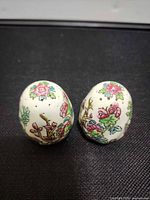 Pair of Coalport Indian Tree shakers showing overall design