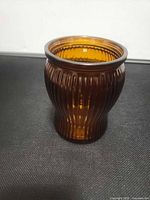 Front view of amber ribbed glass jar