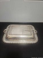 Top view of assembled covered dish showing beaded rim and handles