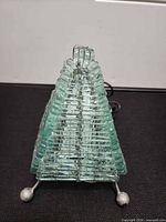 Front view of pyramid lamp showing stacked glass and metal feet