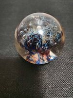 Front view of glass paperweight showing internal jellyfish design