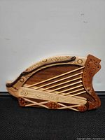 Front view showing full harp-shaped carving and Celtic motifs