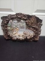 Front view of resin wall plaque displaying lighthouse scene and clock