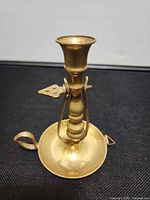 Front view showing full brass chamberstick with handle and wick trimmer
