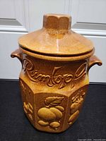 Front view showing lid, Rumtopf script, fruit relief, brown glaze