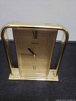 Front view showing gold tone Seiko clock face, Roman numerals XII and VI