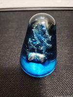 Front view of conical blue swirl paperweight