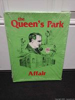 Front view of shrinkwrapped green box displaying title and illustration