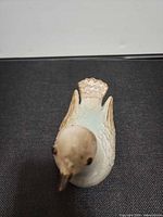 Top view of ceramic bird figurine showing glaze and tail detail