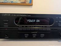 Front close-up showing Carver logo, model CT-26v, display lit "Power On"