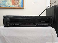 Front view of Carver MV-5 CD player showing entire faceplate, handles, display and controls