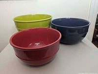 Three ceramic bowls side by side showing colors and size differences
